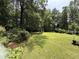 Spacious backyard surrounded by mature trees and landscaping, offering privacy and serenity at 509 Forest Ridge Rd, Garner, NC 27529