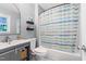 Bathroom with a tub and shower combination, a window, and open storage space at 509 Forest Ridge Rd, Garner, NC 27529