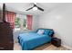 Cozy bedroom with view to the front yard, ceiling fan and wood-look flooring at 509 Forest Ridge Rd, Garner, NC 27529