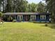 Charming blue single-story home featuring a lush front yard and covered carport at 509 Forest Ridge Rd, Garner, NC 27529