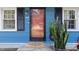 Close up of the front door with a welcome mat and snake plant in a pot at 509 Forest Ridge Rd, Garner, NC 27529