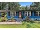 Close-up of the front of a blue home with black shutters and a red door at 509 Forest Ridge Rd, Garner, NC 27529