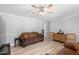 Cozy living room with hardwood floors, ceiling fan, and a brown sofa at 509 Forest Ridge Rd, Garner, NC 27529