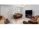 Comfortable living room featuring a love seat with natural light and an entertainment center at 509 Forest Ridge Rd, Garner, NC 27529