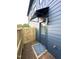 Side entrance with a covered awning and access to a fenced-in backyard with stone accents at 517 Coleman St, Raleigh, NC 27610
