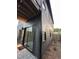 View of the exterior of the home featuring sliding glass doors and dark siding for a modern design at 517 Coleman St, Raleigh, NC 27610