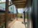 Covered patio with stone floors leading to sliding glass doors and the home's backyard at 517 Coleman St, Raleigh, NC 27610