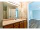 Bathroom featuring large mirror, sink with cabinets, window and views to shower at 518 S Coalport Dr, Apex, NC 27502