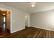 Bedroom with closet, wood floors, neutral walls and a door to other rooms at 518 S Coalport Dr, Apex, NC 27502