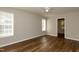 Bedroom showcasing wood floors, neutral walls, and bright windows letting in natural light at 518 S Coalport Dr, Apex, NC 27502