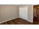 This bedroom features wood floors and a closet with bi-fold doors at 518 S Coalport Dr, Apex, NC 27502