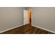 This bedroom features wood floors and a white door to the bathroom at 518 S Coalport Dr, Apex, NC 27502