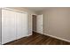 This bedroom features wood floors and a closet with bi-fold doors at 518 S Coalport Dr, Apex, NC 27502