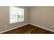 This bedroom has wood floors and a bright window letting in natural light at 518 S Coalport Dr, Apex, NC 27502