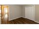 This bedroom features wood floors and a closet with bi-fold doors at 518 S Coalport Dr, Apex, NC 27502
