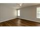 Bedroom with light gray walls, wood floor, ceiling fan, and lots of natural light at 518 S Coalport Dr, Apex, NC 27502