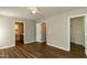 Spacious bedroom with wood floors and multiple doors leading to other rooms at 518 S Coalport Dr, Apex, NC 27502