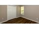 Bedroom showcasing wood floors, neutral walls, a closet and bright windows at 518 S Coalport Dr, Apex, NC 27502