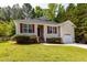 A cozy single-story home features a well-kept lawn, red shutters, and an attached single car garage at 518 S Coalport Dr, Apex, NC 27502