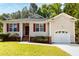 Charming single-story home featuring red shutters, a well-manicured lawn, and an attached one-car garage at 518 S Coalport Dr, Apex, NC 27502