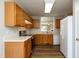 Spacious kitchen with wood cabinets, stainless steel appliances and wood-style floors at 518 S Coalport Dr, Apex, NC 27502