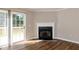 View of a living room highlighting a fireplace and sliding doors to a deck at 518 S Coalport Dr, Apex, NC 27502