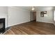 Living room with wood flooring, a fireplace and open view into the kitchen at 518 S Coalport Dr, Apex, NC 27502