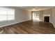 Bright living room with a fireplace, sliding glass doors, and wood-style flooring at 518 S Coalport Dr, Apex, NC 27502