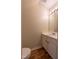 Bathroom with vanity and sink, bright lighting, and wood style flooring at 5209 Echo Ridge Rd, Raleigh, NC 27612