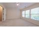 Bedroom featuring vaulted ceilings, carpeted flooring, and large windows offering plenty of natural light at 5209 Echo Ridge Rd, Raleigh, NC 27612