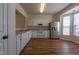 Large kitchen features white cabinets, stainless steel refrigerator and eat-in breakfast nook with windows at 5209 Echo Ridge Rd, Raleigh, NC 27612