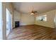 Spacious living room featuring a cozy fireplace, sliding glass doors, and open floor plan at 5209 Echo Ridge Rd, Raleigh, NC 27612