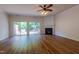 Inviting living room with a fireplace, slider access to the backyard, and laminate flooring at 5209 Echo Ridge Rd, Raleigh, NC 27612