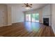 Spacious living room with hardwood floors, fireplace, and sliding glass doors to the backyard at 5209 Echo Ridge Rd, Raleigh, NC 27612