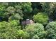 Overhead view of the house surrounded by lush greenery showcasing its secluded location and tree coverage at 5304 Cypress Ln, Raleigh, NC 27609