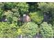 A charming home with a brown roof is nestled among lush green trees, creating a private, wooded oasis at 5304 Cypress Ln, Raleigh, NC 27609