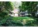 Lush backyard features a well-manicured lawn, mature trees, and an inviting patio area for outdoor enjoyment at 5304 Cypress Ln, Raleigh, NC 27609