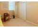 Bedroom featuring a closet with a mirror, a window, and hardwood floors at 5304 Cypress Ln, Raleigh, NC 27609