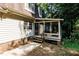 View of home's exterior showcasing the back patio and sunroom, accessible from the backyard at 5304 Cypress Ln, Raleigh, NC 27609