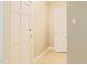 Neutral hallway featuring multiple white paneled doors and neutral colored tile at 5304 Cypress Ln, Raleigh, NC 27609