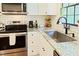 Bright kitchen featuring stainless appliances, subway tile backsplash, and light countertops at 5304 Cypress Ln, Raleigh, NC 27609