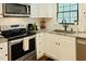 Bright kitchen featuring stainless appliances, subway tile backsplash, and light countertops at 5304 Cypress Ln, Raleigh, NC 27609
