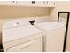 A well-equipped laundry room with washer and dryer, and upper cabinets at 5304 Cypress Ln, Raleigh, NC 27609