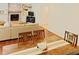 Living room with a dining area, hardwood floors, and a cozy brick fireplace at 5304 Cypress Ln, Raleigh, NC 27609