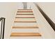 Stairway with white risers and wood treads leading to the next level at 5304 Cypress Ln, Raleigh, NC 27609