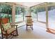 Bright sunroom features walls of windows and comfortable seating, perfect for enjoying the outdoors from inside at 5304 Cypress Ln, Raleigh, NC 27609