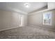 Spacious bedroom with tray ceiling, carpet, and natural light at 5504 Jaeger Dr # 76, Graham, NC 27253