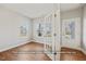 Bright interior room with wood floors, large windows, and elegant French doors at 5504 Jaeger Dr # 76, Graham, NC 27253