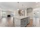Open floor plan with kitchen island overlooking a spacious living area, fireplace and staircase at 5504 Jaeger Dr # 76, Graham, NC 27253