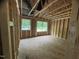 Exposed wood frame room showcasing window views and construction progress; unfinished at 5504 Jaeger Dr # 76, Graham, NC 27253